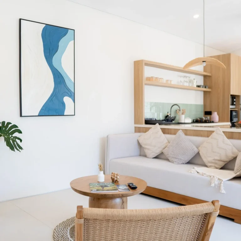 Modern living room in a luxury villa in Kuta Lombok with natural wood design and open-plan kitchen